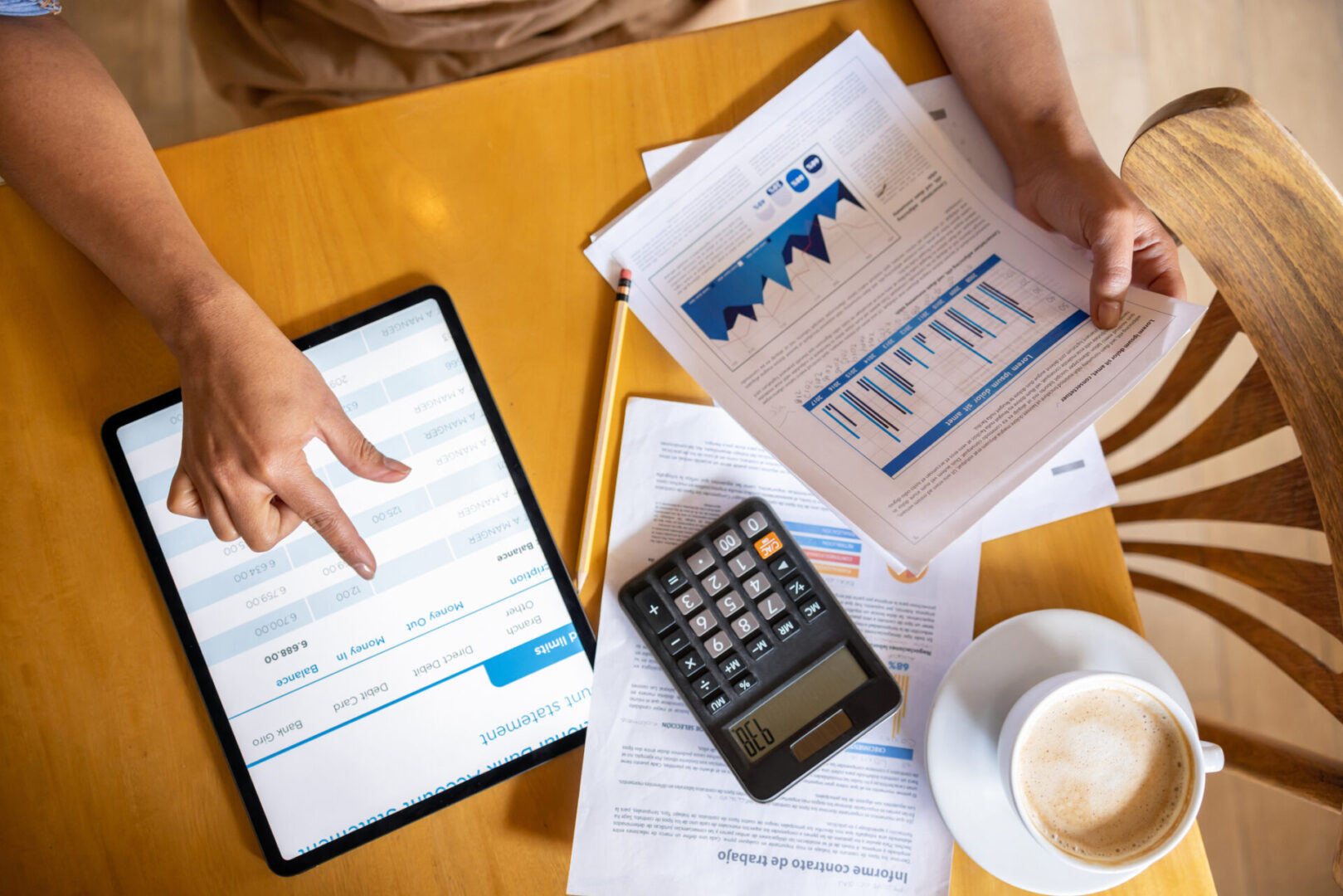 Person reviewing financial reports and graphs
