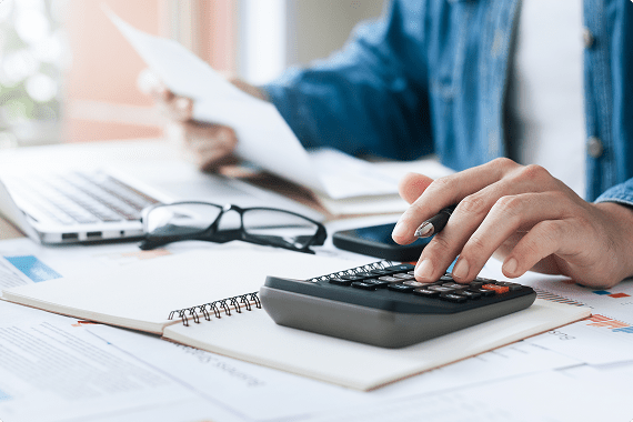 Man working with calculator and papers