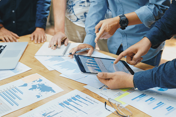 Team analyzing data with charts on table
