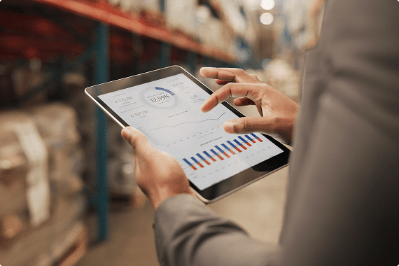 Business professional using tablet in warehouse