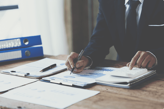 Man working with reports and binders